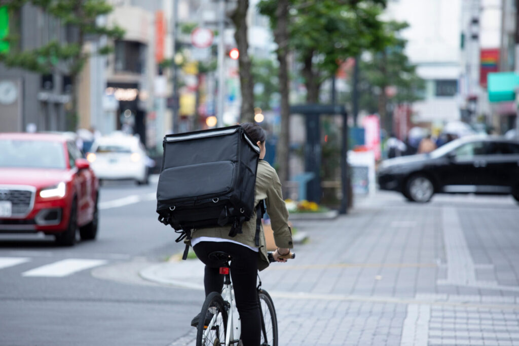 自転車で配達を行う女性