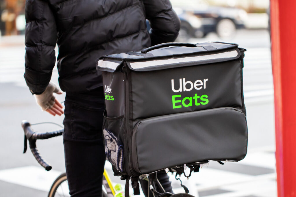 UberEatsの配達バッグを自転車に設置いている人